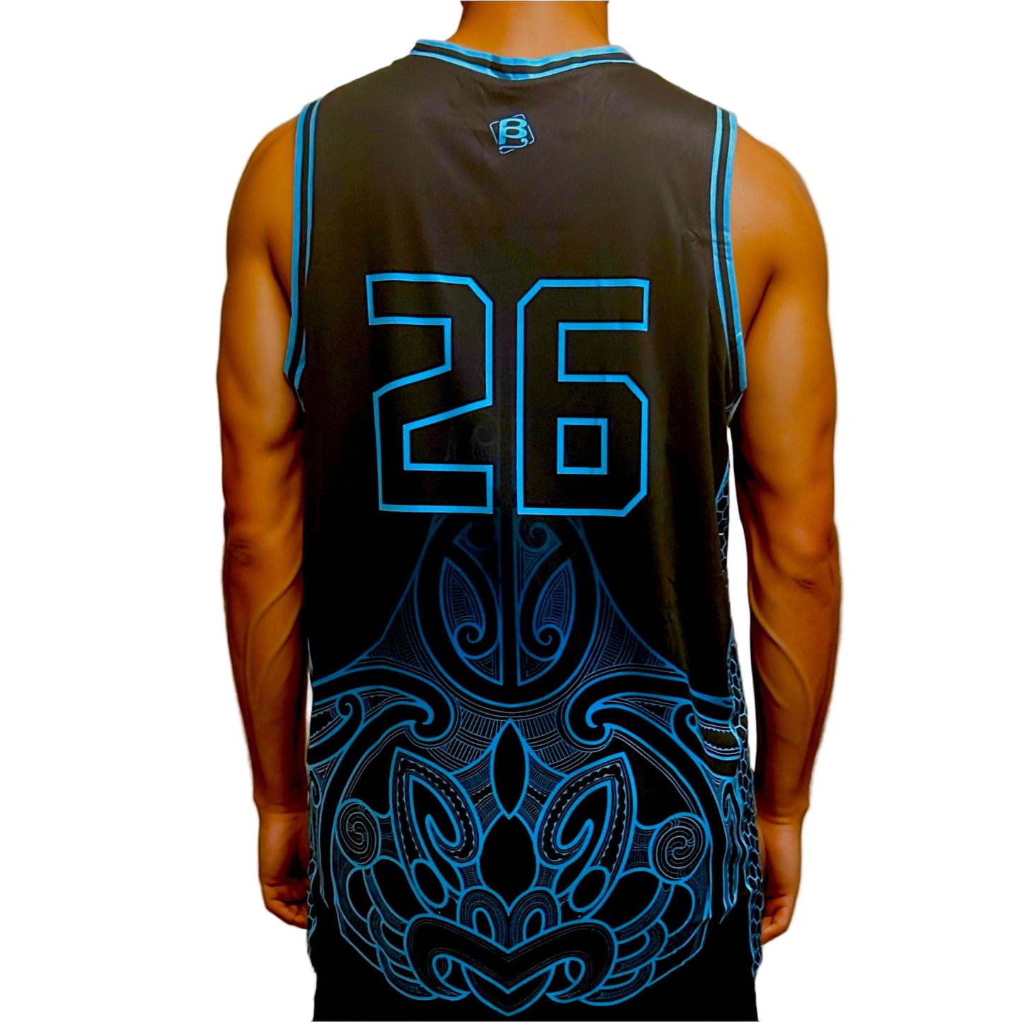Person wearing a black basketball jersey with blue numbering and Maori patterns on a plain background